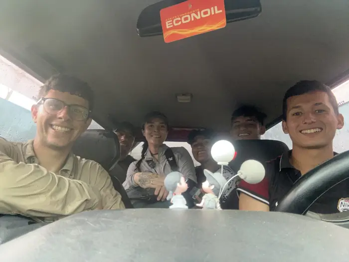 Toucan and biodiversity monitoring team taking refuge from the rain